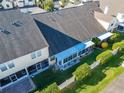 Aerial view of a home with a screened lanai, enclosed porch, and a well maintained yard at 1050 Starkey Rd # 704, Largo, FL 33771