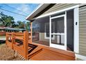 Screened porch with wooden steps and railings at 1100 E Louisiana Ave, Tampa, FL 33603