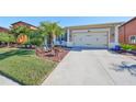 House exterior showcasing a well-manicured lawn and driveway at 13230 Fawn Lily Dr, Riverview, FL 33579