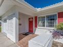 Red front door, tiled porch, and white exterior at 14181 89Th Ave, Seminole, FL 33776