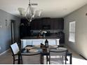 Kitchen with an island and adjacent dining area with table and chairs at 14207 Alistar Manor Dr, Wimauma, FL 33598