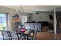 Open living and dining area with hardwood floors and a comfortable seating area at 14207 Alistar Manor Dr, Wimauma, FL 33598