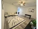 Open living area showcasing a comfortable sectional sofa, foosball table, and stylish rug at 3208 Deleuil Ave, Tampa, FL 33610