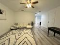 Spacious living room with L-shaped sofa, foosball table, and modern decor at 3208 Deleuil Ave, Tampa, FL 33610