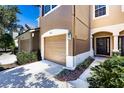 Townhome exterior showcasing the front door and attached garage at 4904 Barnstead Dr, Riverview, FL 33578