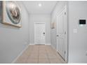 Bright and airy entryway with tile flooring and neutral walls at 9709 Pembrooke Pines Dr, Sun City Center, FL 33573