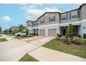 Two-story townhome with attached garage and landscaping at 9709 Pembrooke Pines Dr, Sun City Center, FL 33573