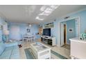 Open living space with light blue walls, comfy furniture, and views at 10216 Regal Dr # 603, Largo, FL 33774