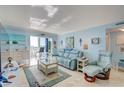 Relaxing living room featuring light blue walls, comfortable seating, and coastal decor at 10216 Regal Dr # 603, Largo, FL 33774