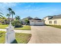 Two-story house with a three-car garage and a brick driveway at 10511 Martinique Isle Dr, Tampa, FL 33647