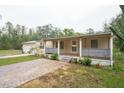 Single story home with covered front porch and brick paver driveway at 11730 Chipley St, New Port Richey, FL 34654