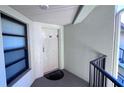 Condo entryway with door and small balcony at 1515 Pinellas Bayway S # 35, Tierra Verde, FL 33715