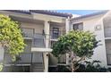 Exterior view of condo building with stairs and landscaping at 1515 Pinellas Bayway S # 35, Tierra Verde, FL 33715