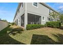 Ground level screened porch with lawn and landscaping at 2101 Sunset Wind Loop, Oldsmar, FL 34677