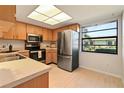Clean kitchen with stainless steel appliances and light wood cabinets at 2122 Hereford Dr # 511, Sun City Center, FL 33573