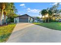 Newly paved driveway leading to a renovated home exterior at 5472 Cactus Cir, Spring Hill, FL 34606