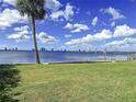 Scenic waterfront property with a grassy yard, boat lift, and city views at 560 Riviera Dr, Tampa, FL 33606