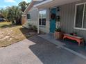 Front view of a charming house with teal door and walkway at 7045 Lenox Dr, New Port Richey, FL 34653