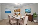 A staged dining room with marble table, upholstered chairs, art and recessed lighting at 13608 S Village Dr # 6105, Tampa, FL 33618