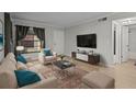 Bright living room with modern furniture, accent pillows, and a large window at 13608 S Village Dr # 6105, Tampa, FL 33618