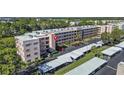 Aerial view showcasing condo building and parking at 5980 80Th N St # 204, St Petersburg, FL 33709