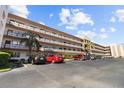 Condo building exterior with ample parking at 5980 80Th N St # 204, St Petersburg, FL 33709