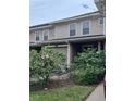 Two-story townhome with a garage and well-manicured landscaping at 8003 Bally Money Rd, Tampa, FL 33610