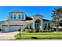 Beautiful two-story home with lush landscaping, inviting curb appeal, and attached two car garage at 8319 Swiss Chard Cir, Land O Lakes, FL 34637