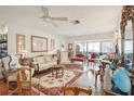 Elegant living room with hardwood floors, ornate furniture, and ample natural light at 9302 Trowbridge Ct, New Port Richey, FL 34655