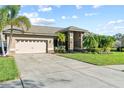 House exterior showcasing a two-car garage and well-maintained landscaping at 1035 Wyndham Way, Safety Harbor, FL 34695