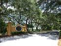 Entrance to St. Charles Place community, featuring a sign and mature oak trees at 10817 Great Carlisle Ct, Riverview, FL 33578