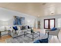 Bright living room with a comfortable sofa, stylish decor, and a glass coffee table on a patterned rug at 1131 Snell Isle Ne Blvd, St Petersburg, FL 33704