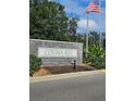 Covina Key community entrance sign with American flag at 1252 Costa Mesa Dr, Wesley Chapel, FL 33543