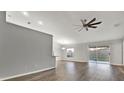 Spacious living room featuring wood-look floors and access to backyard at 12612 Midpointe Dr, Riverview, FL 33579