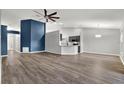 Open-concept living room with kitchen island and modern finishes at 12612 Midpointe Dr, Riverview, FL 33579