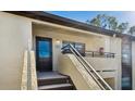 Condo building exterior with stairs leading to private entrance and balcony at 13608 S Village Dr # 6203, Tampa, FL 33618