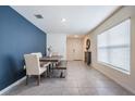 Bright dining area with a modern table, bench seating, and stylish decor at 16838 Delia St, Wimauma, FL 33598