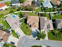 Aerial view of a residential neighborhood showcasing a house with a pool at 2012 Fern Ridge Ct, Holiday, FL 34691