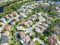 Wide aerial view of a residential community with numerous houses at 2012 Fern Ridge Ct, Holiday, FL 34691