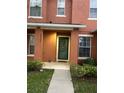 Front entrance to a townhome with a welcome mat and landscaping at 2066 Sun Down Dr 2066 Sun Down Dr, Clearwater, FL 33763