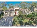 Single-story house with a large yard and driveway at 3125 Bent Creek Dr, Valrico, FL 33596