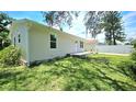 Exterior view of the home showcasing the back yard and the side yard at 3562 Fisher Rd, Palm Harbor, FL 34683