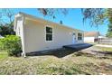 An inviting one-story home featuring a modern exterior with fresh paint, updated windows, and a concrete porch at 3562 Fisher Rd, Palm Harbor, FL 34683