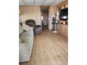 Living room with recliner, sofa and wood-look flooring at 519 51St Avenue W Ter, Bradenton, FL 34207