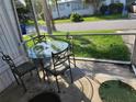 Screened porch with glass-top table and four chairs at 519 51St Avenue W Ter, Bradenton, FL 34207