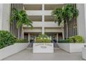 Front entrance of Chateau Tower 7050, featuring landscaping and building name at 7050 Sunset S Dr # 405, South Pasadena, FL 33707