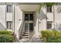 Condo building entrance with well-maintained landscaping and multiple unit access at 122 E Cypress Ct # 22, Oldsmar, FL 34677
