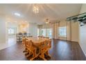 Dining room with wood table and chairs, view of kitchen and sunroom at 1257 Corinth Greens Dr # 1257, Sun City Center, FL 33573