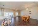 Spacious dining area with dark wood flooring and access to the kitchen and sunroom at 1257 Corinth Greens Dr # 1257, Sun City Center, FL 33573