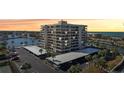 Aerial view showcasing condo building, parking, and waterfront location at 1651 Sand Key Estates Ct # 44, Clearwater Beach, FL 33767